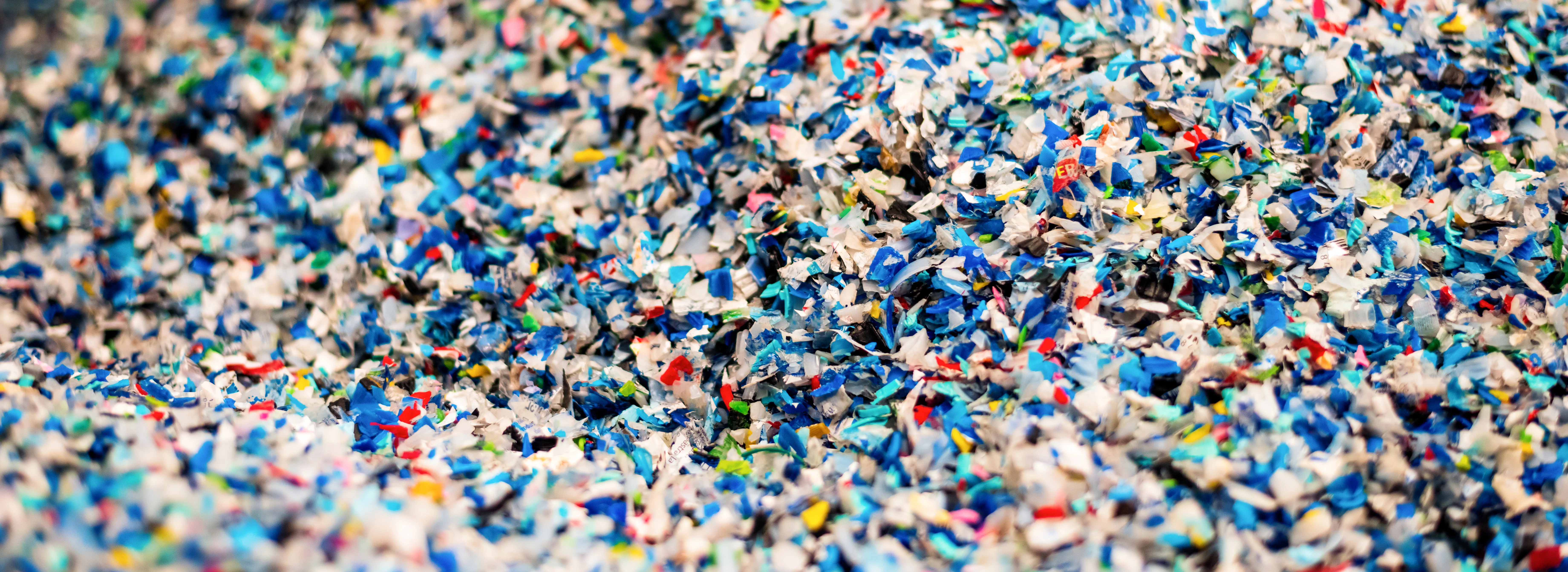 close-view-multicoloured-shredded-plastic-garbage-waste-recycling-factory